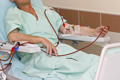 Male patient getting a dialysis treatment at a hospital.